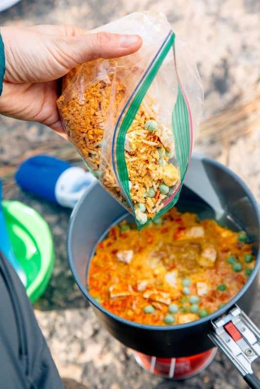 Ingrédients et fournitures pour cuisiner du riz au curry rouge en randonnée.