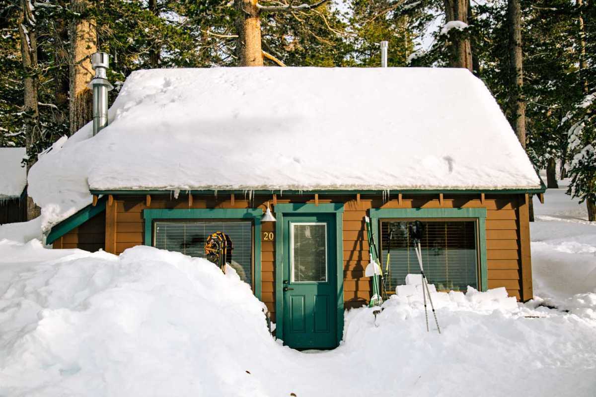 Een rustieke hut bedekt met sneeuw